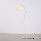 Pleated floor lamp adding soft light to a cosy corner