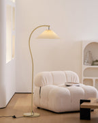 Pleated floor lamp lighting a bedroom corner gently
