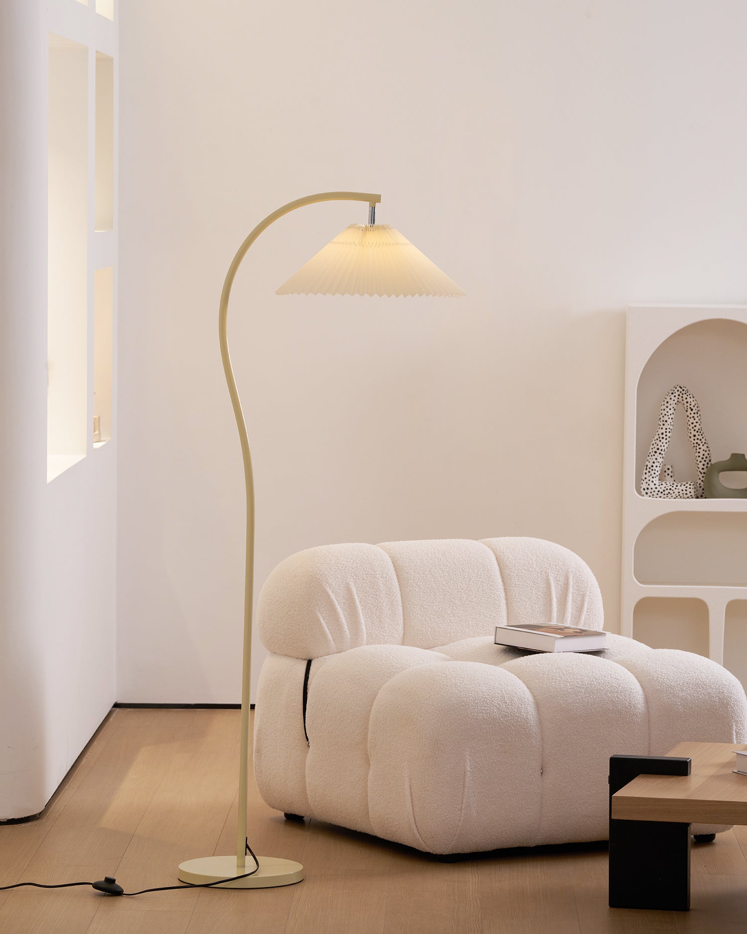 Pleated floor lamp lighting a bedroom corner gently