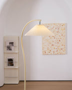 Pleated floor lamp shown full length in a styled interior