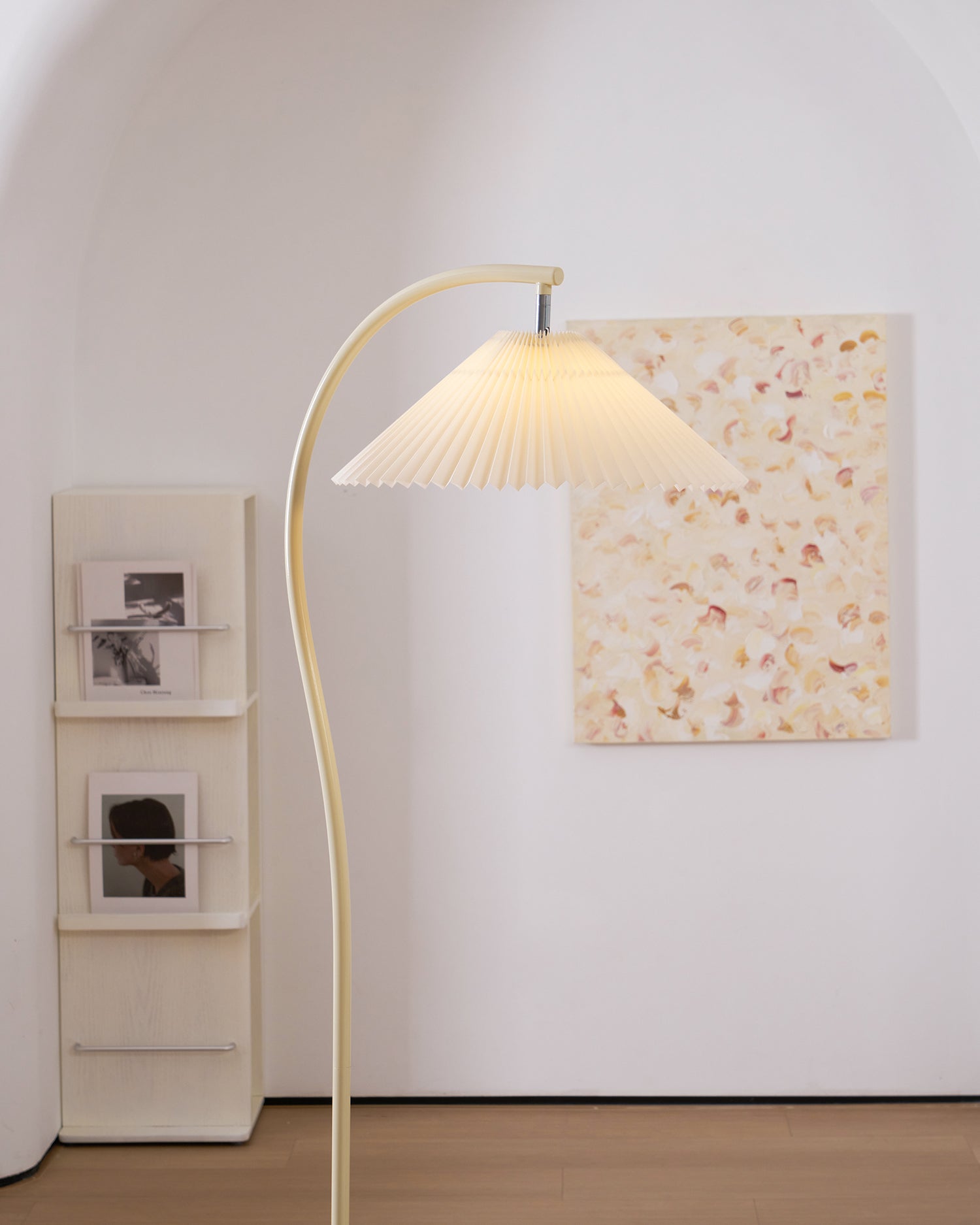 Pleated floor lamp shown full length in a styled interior