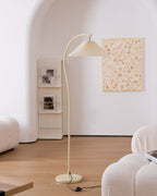 Beech wood and metal frame detail at the base of the pleated floor lamp