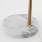 A close-up detail shows the Clérachic lamp's round white marble base and the point where its cord exits near the stem.