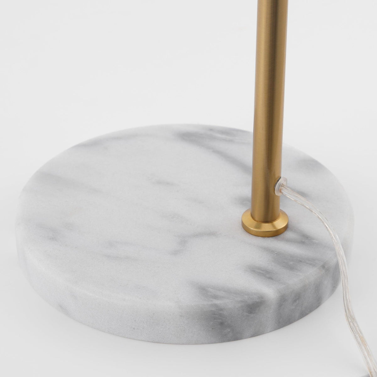 A close-up detail shows the Clérachic lamp's round white marble base and the point where its cord exits near the stem.