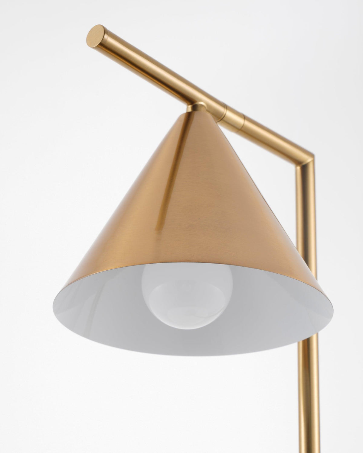 An angled close-up of the Clérachic lamp's cone shade reveals its white interior diffuser and the bulb beneath it.