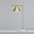 On a pale grey surface, this Clérachic table lamp shows its black power cord trailing away from the round marble base.