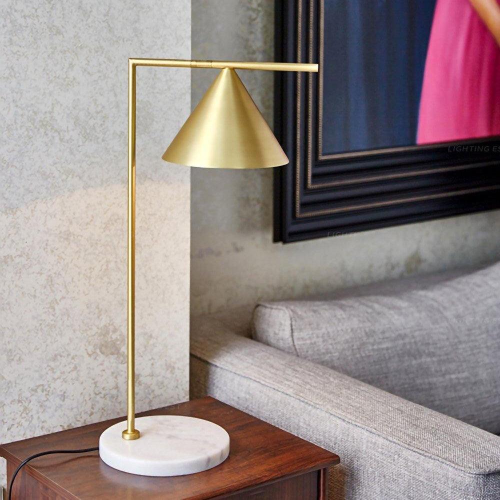 A wider crop of the wood-nightstand scene shows the full stem and marble base of the Clérachic lamp beside the sofa arm.