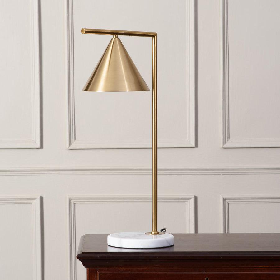 The Clérachic cone-shade lamp is shown on a wood console against a cream panelled wall, a softer backdrop than the grey version.