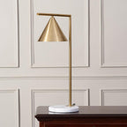 The Clérachic cone-shade lamp is shown on a wood console against a cream panelled wall, a softer backdrop than the grey version.