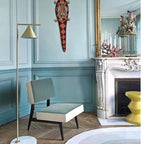 Copper floor lamp with marble base lighting a reading corner