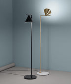 Black-stem floor lamp with cone angled over a side table