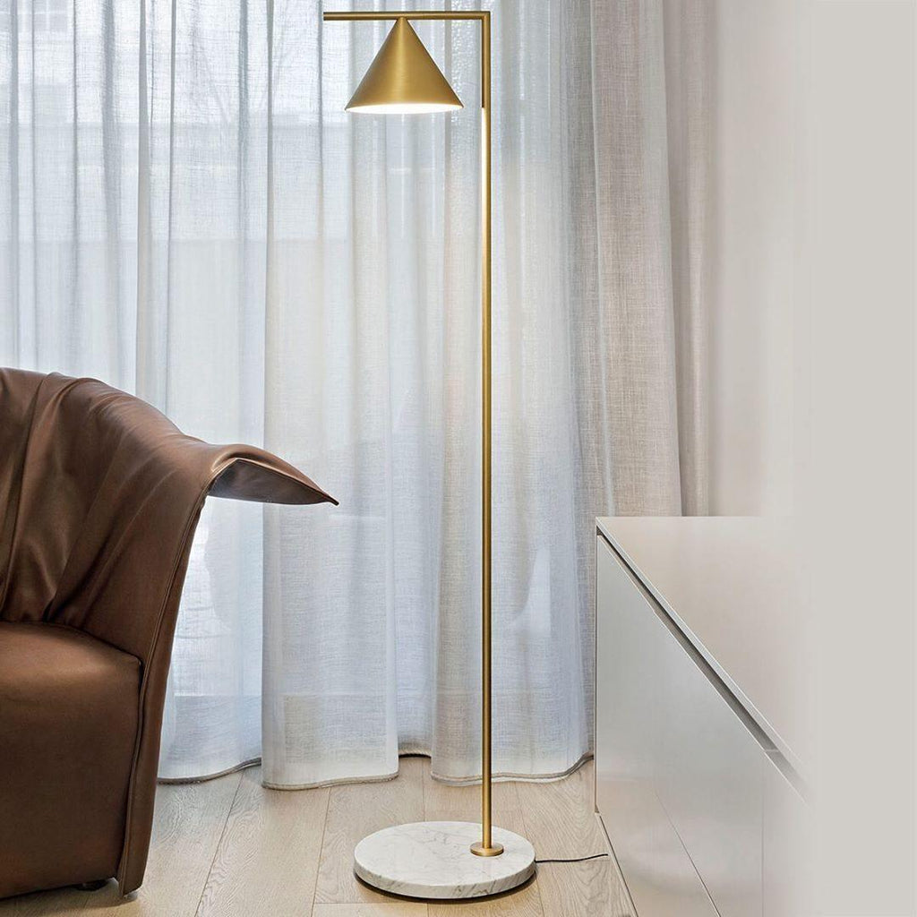 Black-stem floor lamp on a white marble base in a living room