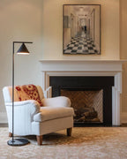 Black floor lamp with cone repositioned for focused reading light