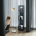 Copper floor lamp with opal cone beside a textured wall