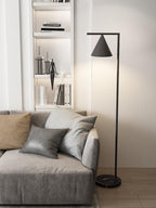 Copper floor lamp with marble base lighting an evening interior