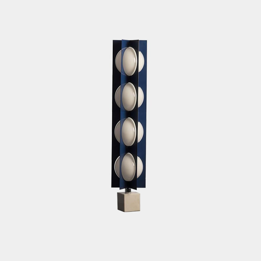 Four-globe Clérachic floor lamp on a warm stone base, shown unlit head-on against a plain grey backdrop.