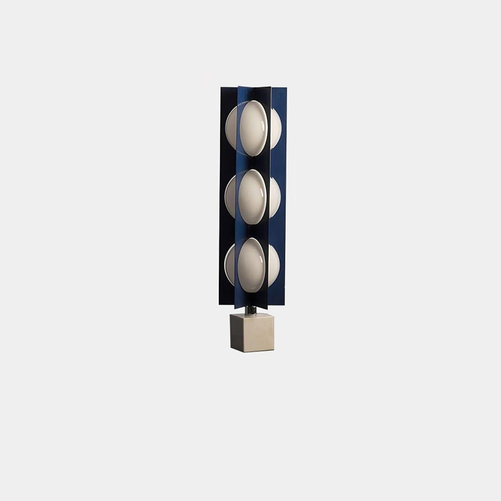 Three-globe Clérachic lamp on a warm stone base, a compact isolated product shot on a plain grey background.