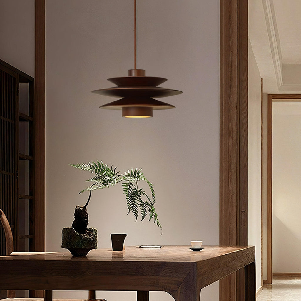 In a warm hallway, this Clérachic pendant in walnut wood hangs above a dark wood table with a small potted fern.