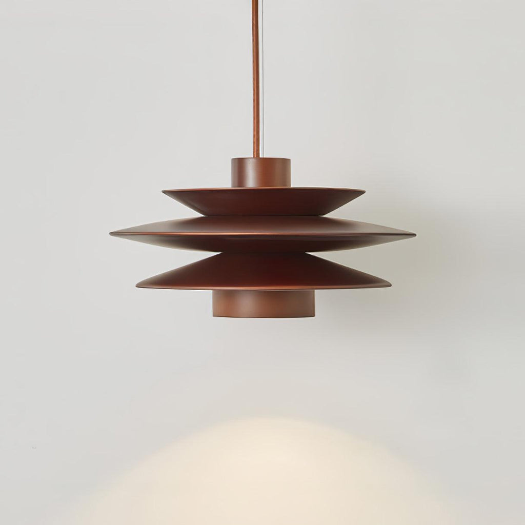 A close side view of this Clérachic pendant in walnut wood on a grey backdrop, its tiered discs glowing warm light.