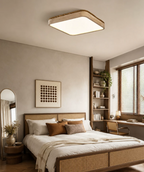 Lit above a rattan-trimmed bed, this Clérachic ceiling light sits near a round mirror and open bookshelf.
