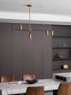 In a warm brown panelled dining room, this Clérachic chandelier hangs above a marble-topped table.