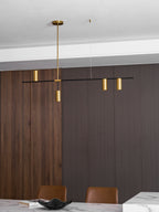 In a dark timber dining room, this Clérachic chandelier's black bar carries gold heads above a marble table edge.