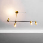Close view of this Clérachic chandelier's angled bar, with a weighted gold disc balancing two spotlight heads.