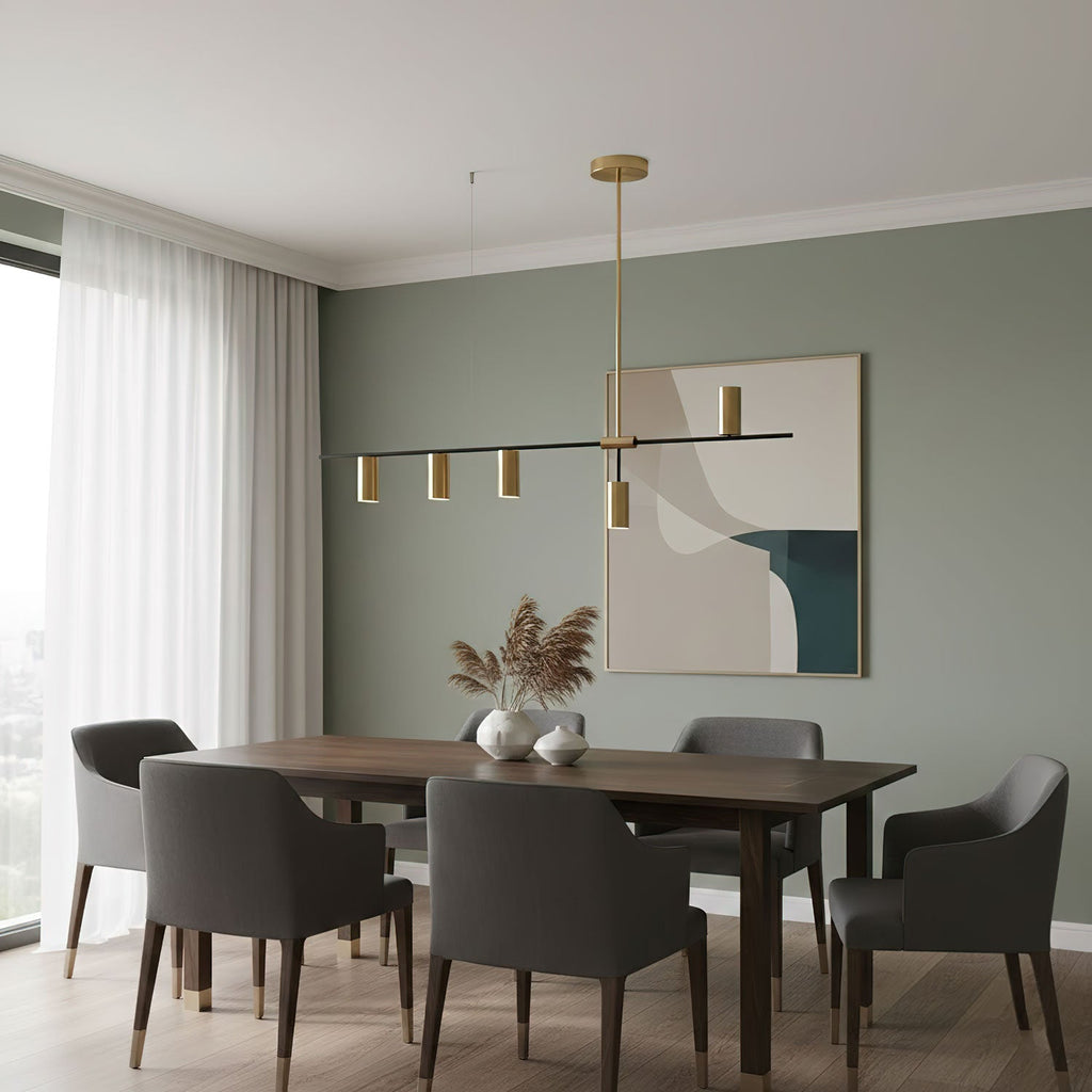 Beneath a sage-green wall and abstract artwork, this Clérachic chandelier hangs above a walnut dining table.