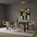 This Clérachic chandelier spans a dark grey dining room, its gold heads angled above a walnut table and cream chairs.