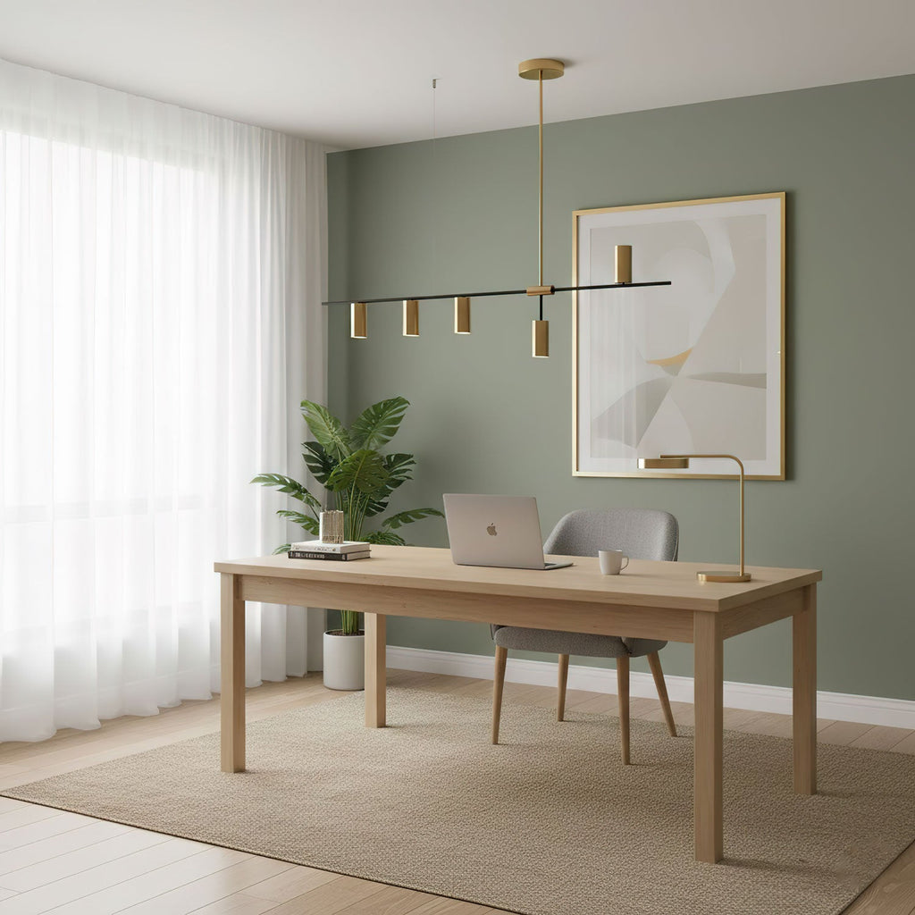 In a home office with sage-green walls, this Clérachic chandelier hangs above a desk and laptop.