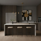This Clérachic chandelier hangs beside a patterned wall canvas, above a stone kitchen island with cream stools.