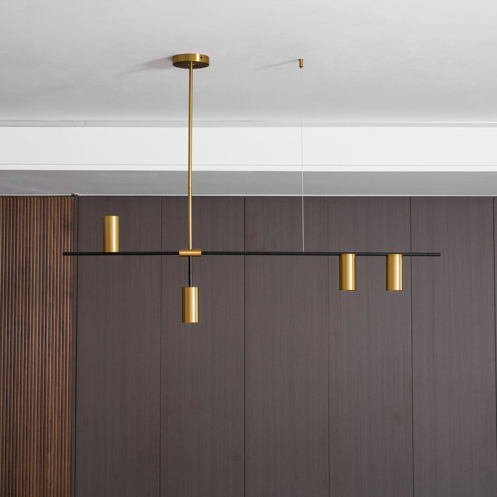 On a plain white background, this Clérachic chandelier's black bar extends further to one side, fitted with gold cylinder heads.