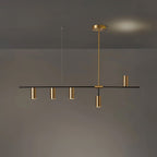 In the gold finish, this Clérachic chandelier's rod and cylinder heads match, seen against a dim backdrop with a warm glow.