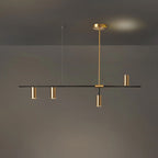 Against a dim grey backdrop with a warm glow behind, this Clérachic chandelier hangs with gold heads clustered near centre.