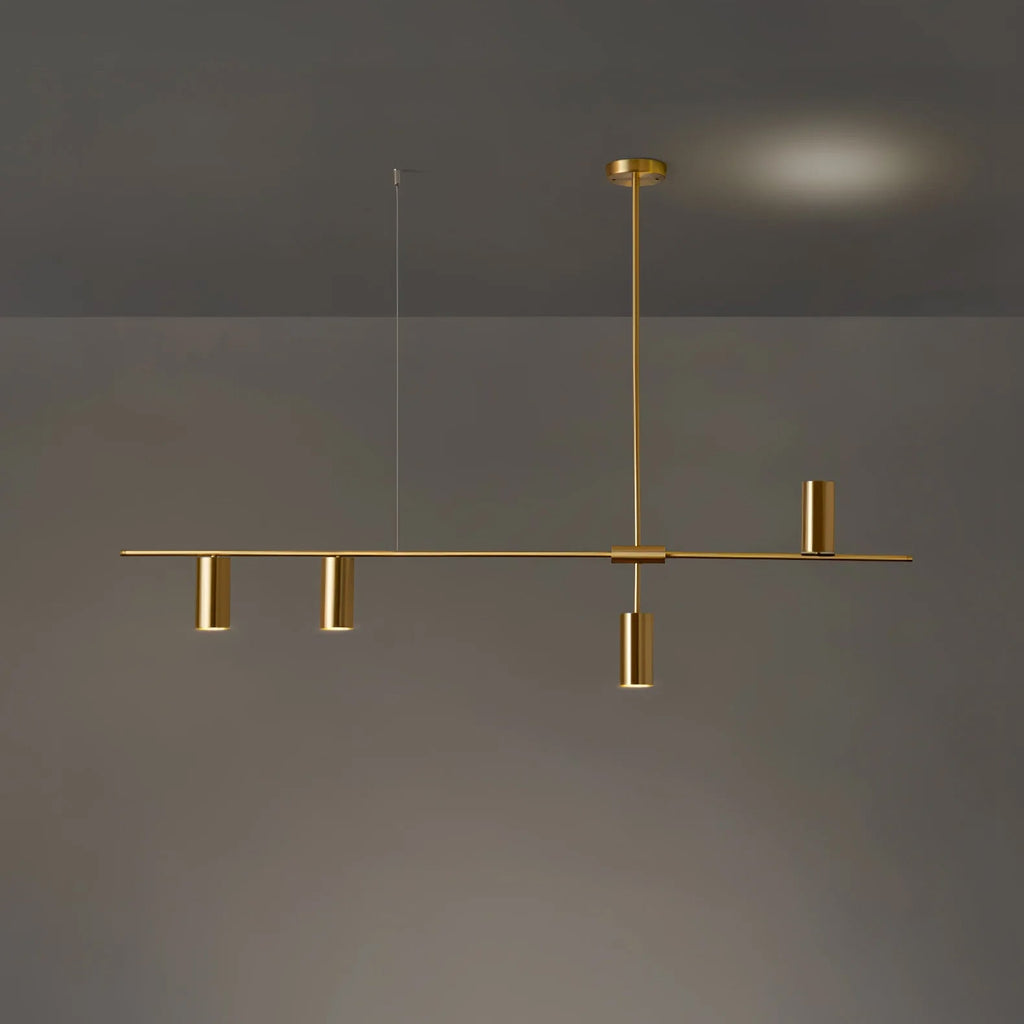 Against a dim grey backdrop with a warm glow behind, this Clérachic chandelier's black bar carries gold heads on a shorter span.