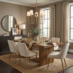 This brass Clérachic chandelier lights a dining room with a round mirror and gold-legged cream chairs.