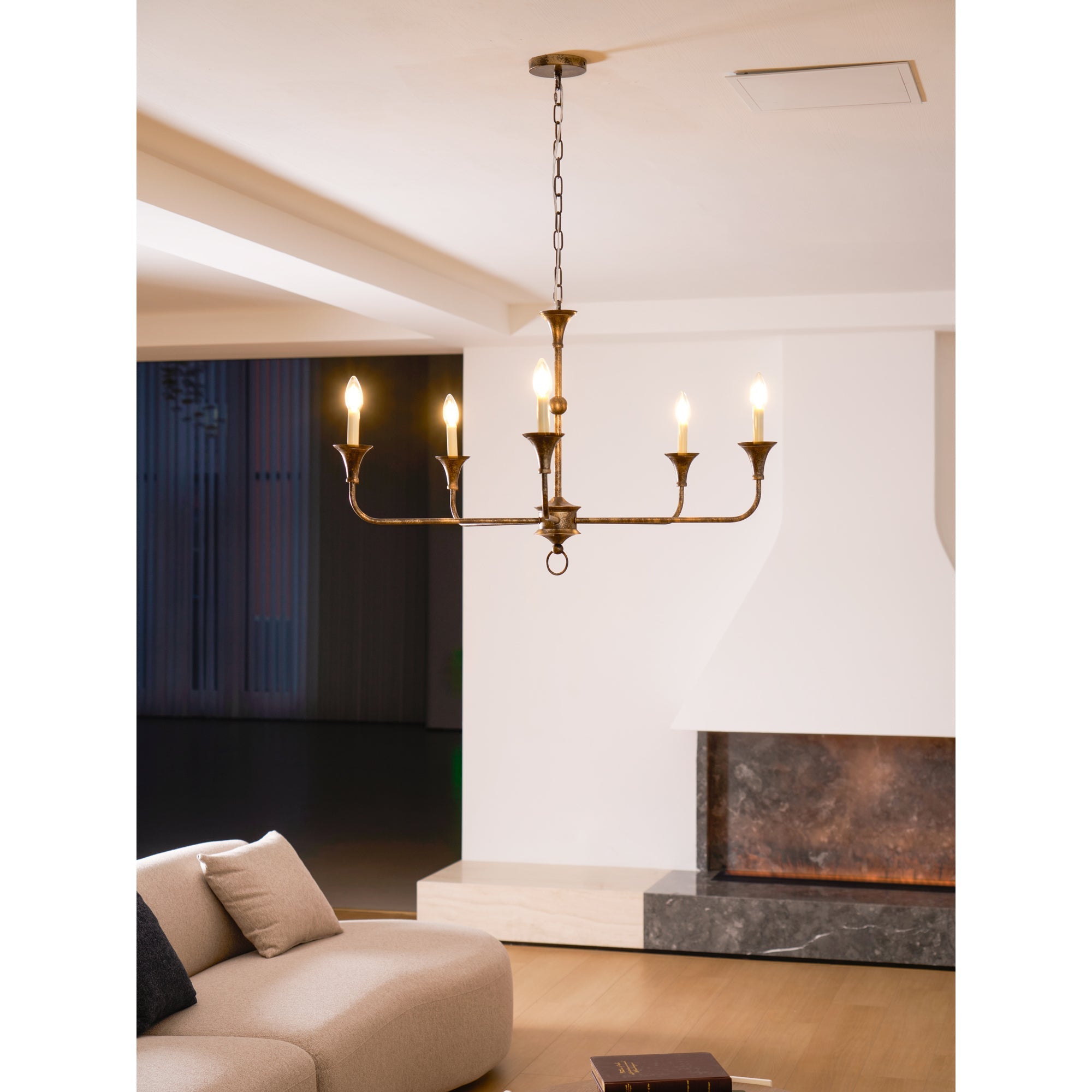 Candle chandelier finish detail on a brass arm