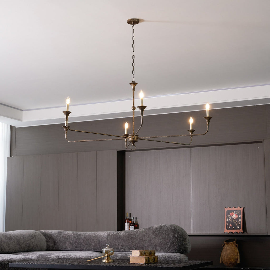 Candle chandelier arm detail with exposed candle bulb fitting
