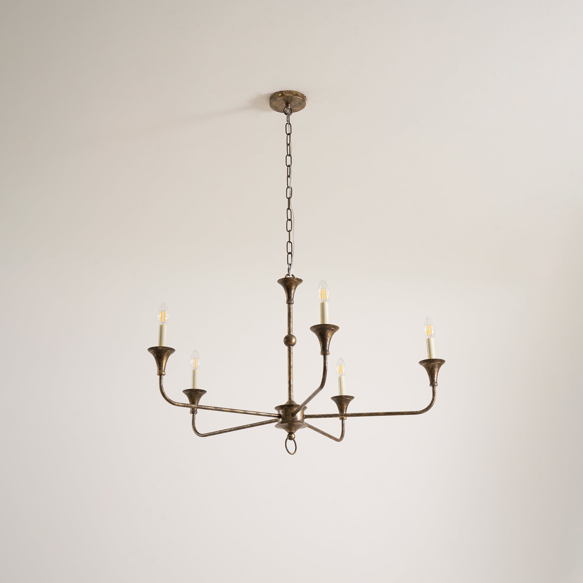 Candle chandelier viewed at an angle showing depth of the brass arms