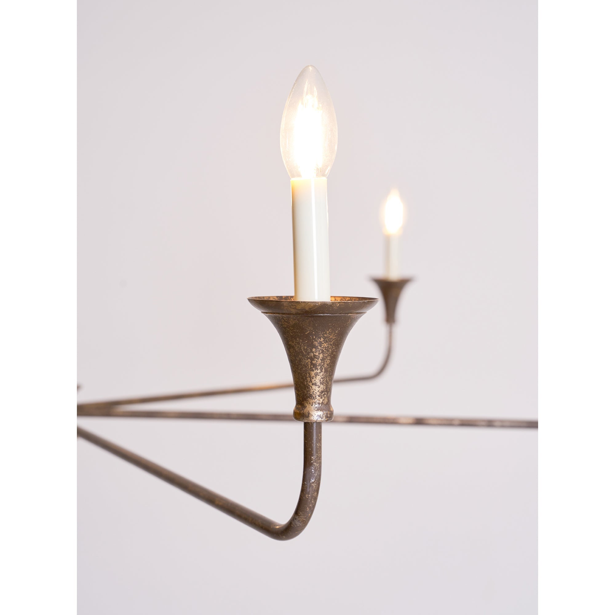 Candle chandelier detail of brass arm and bulb holder