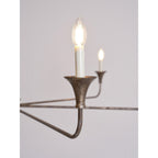 Candle chandelier detail of brass arm and bulb holder