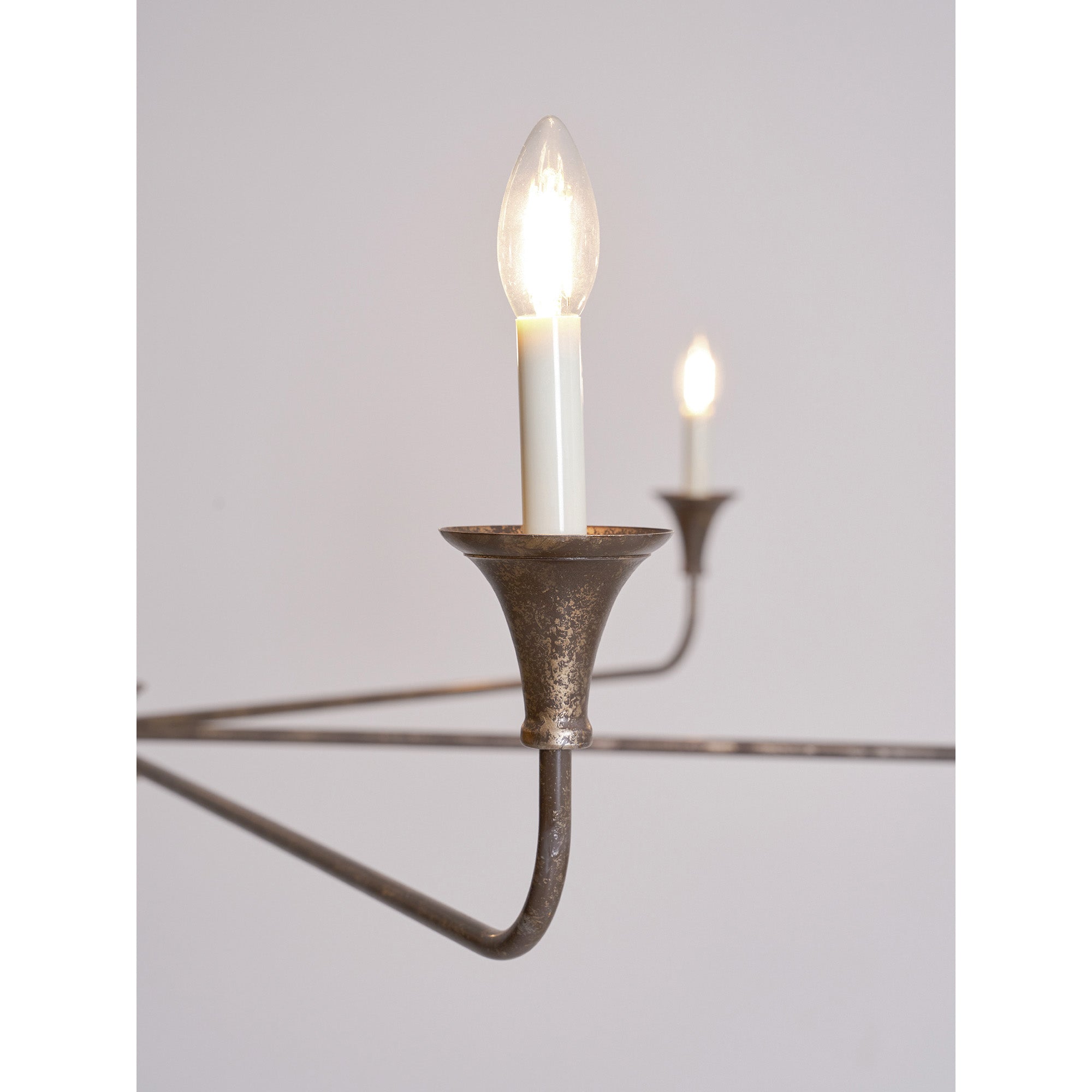 Candle chandelier detail of brass arm and bulb holder