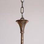 Candle chandelier arm detail in warm brass tone