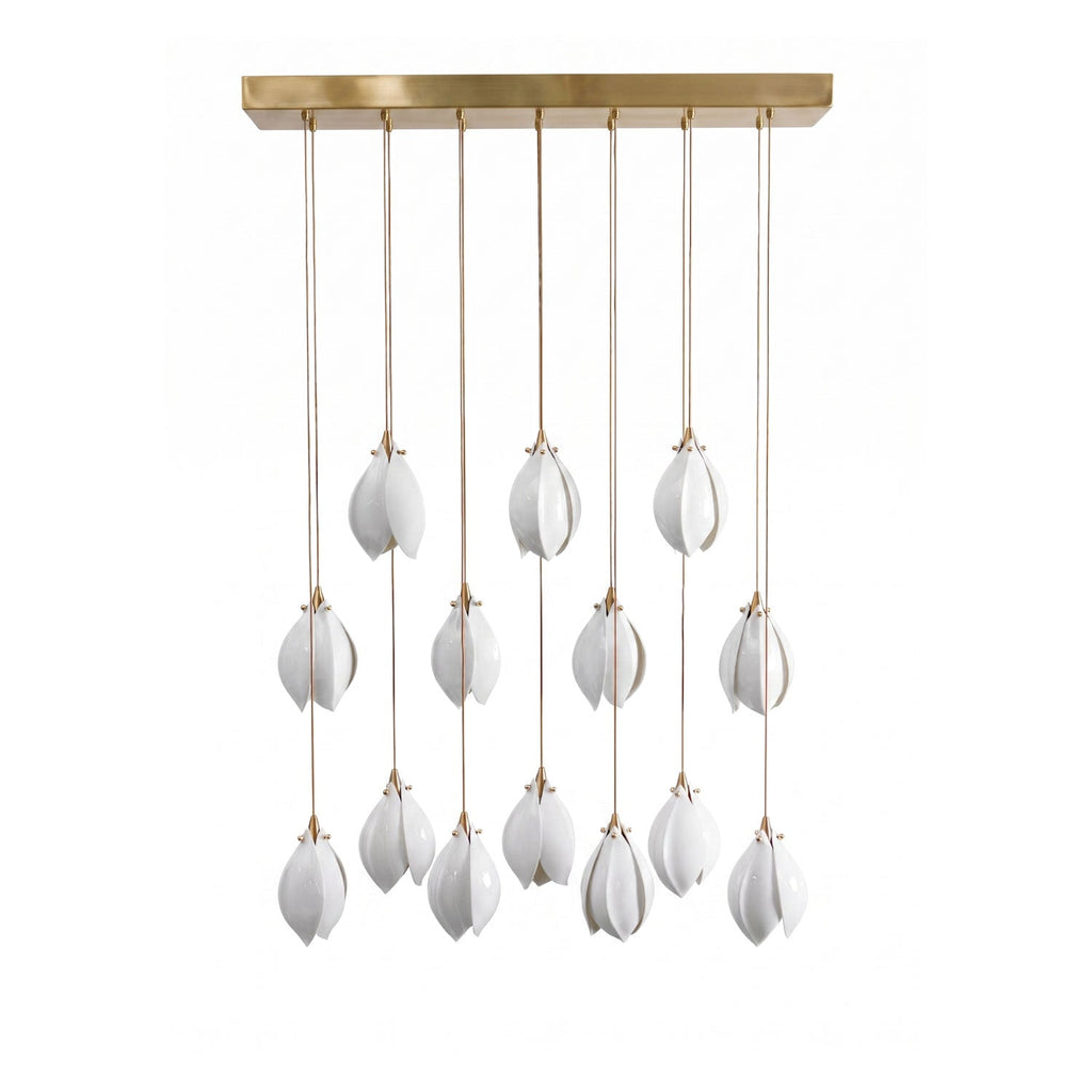 White ceramic flower pendant light glowing over a living space