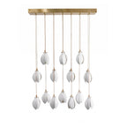 White ceramic flower pendant light glowing over a living space