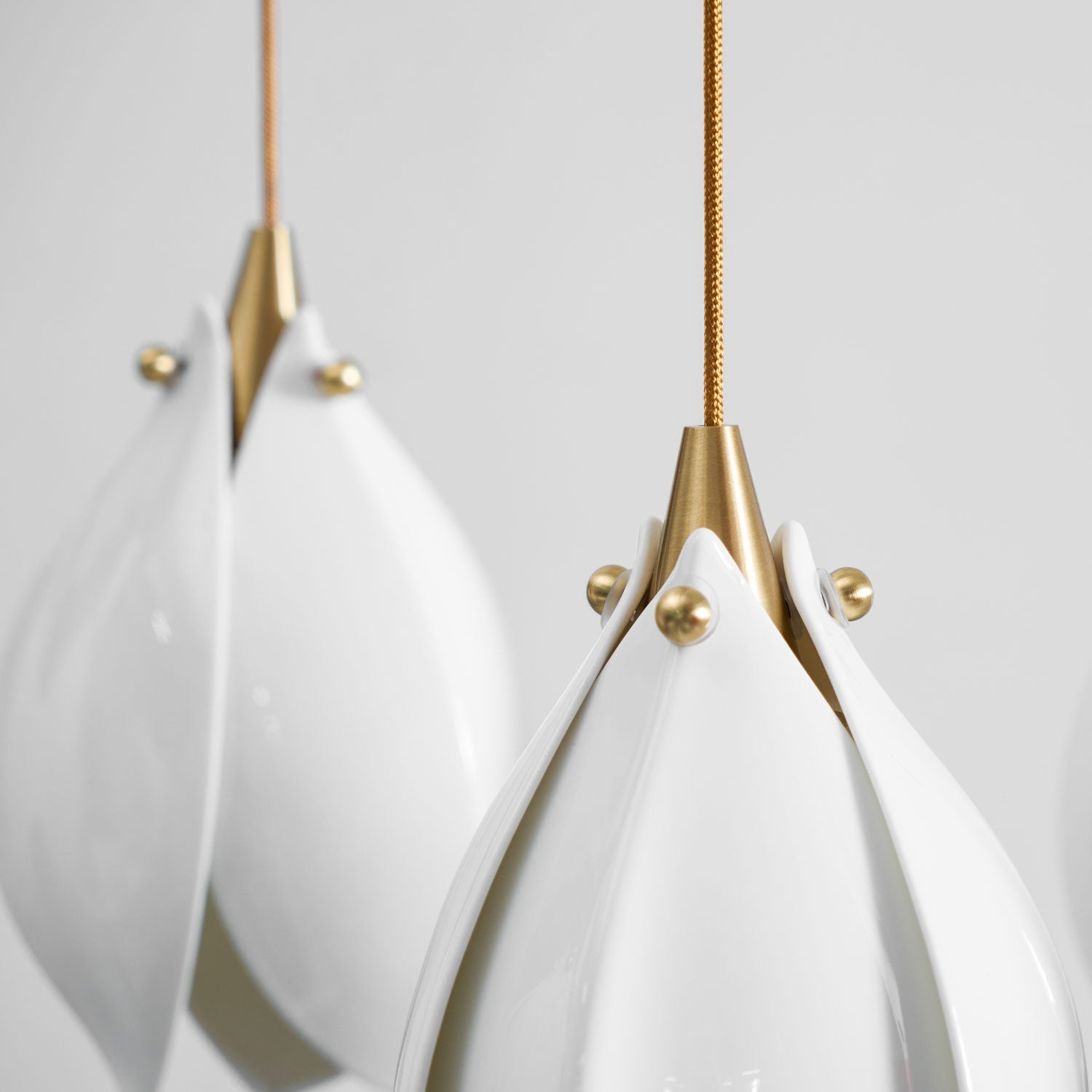 Brass and white ceramic flower pendant light single bloom detail