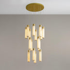 Dense Aurelia cluster viewed from slightly below, brass caps catching light above each stone tube.