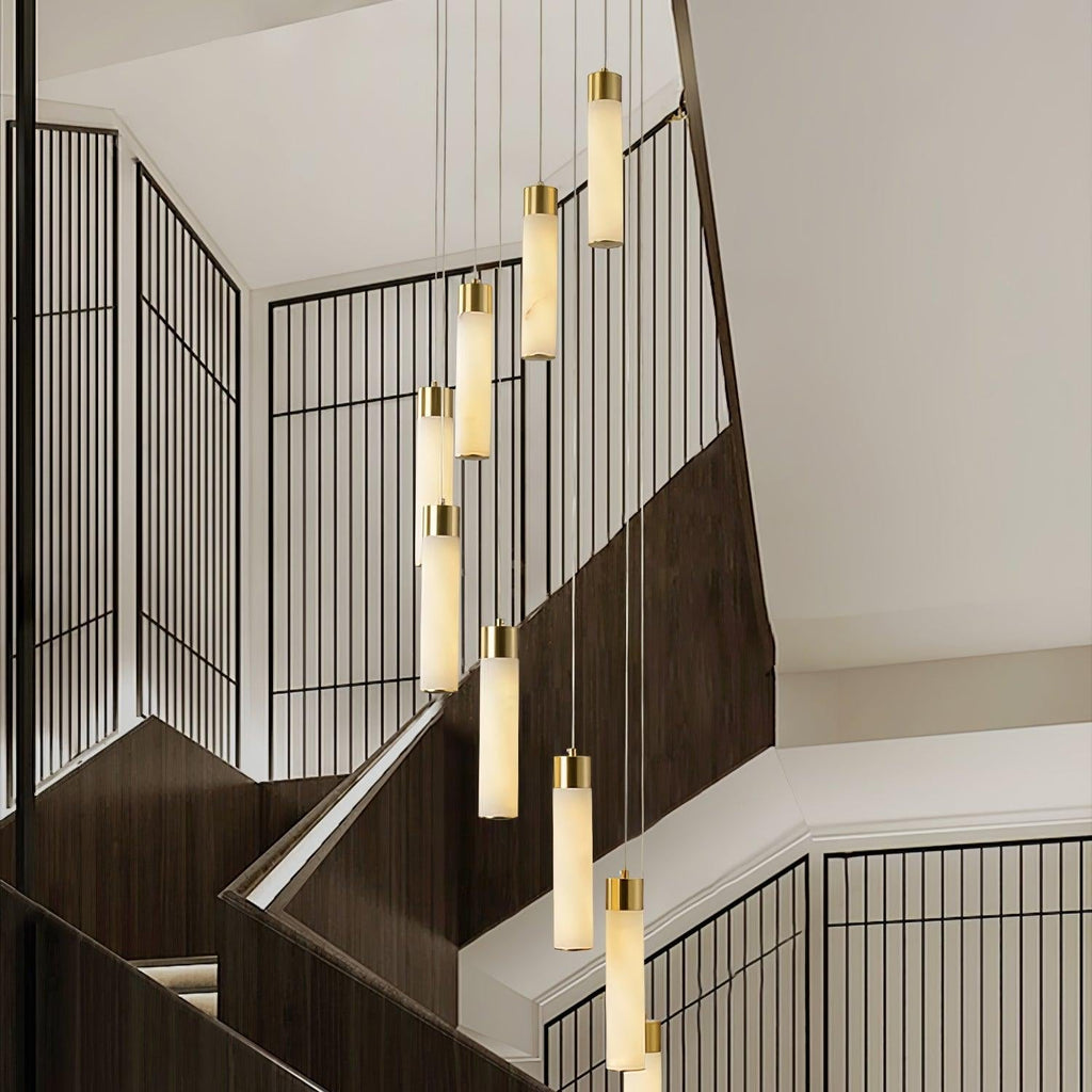 Eight Aurelia pendants stepping down a stairwell, seen at an angle across the black screen wall.