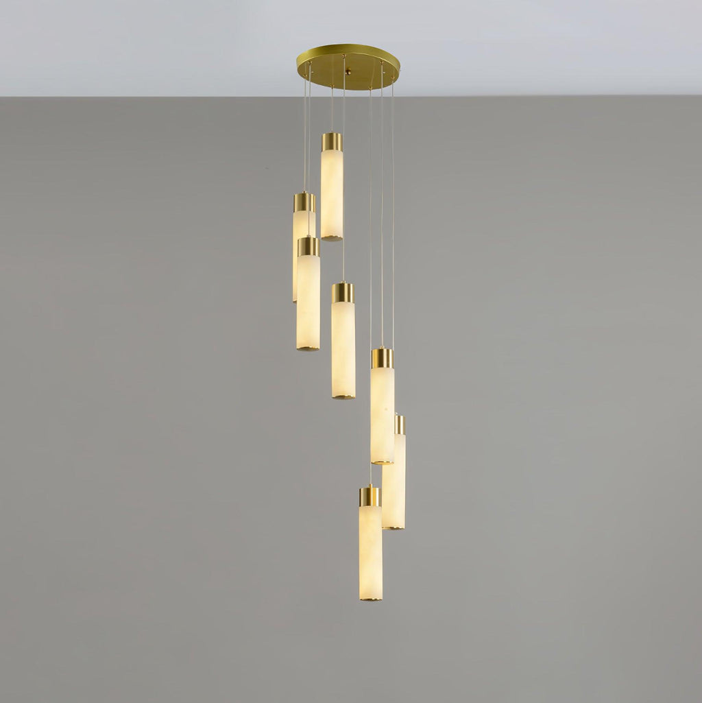 Eight-light Aurelia arrangement in a loose spiral, alabaster tubes lit to a soft amber.