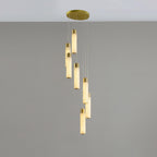 Eight-light Aurelia arrangement in a loose spiral, alabaster tubes lit to a soft amber.